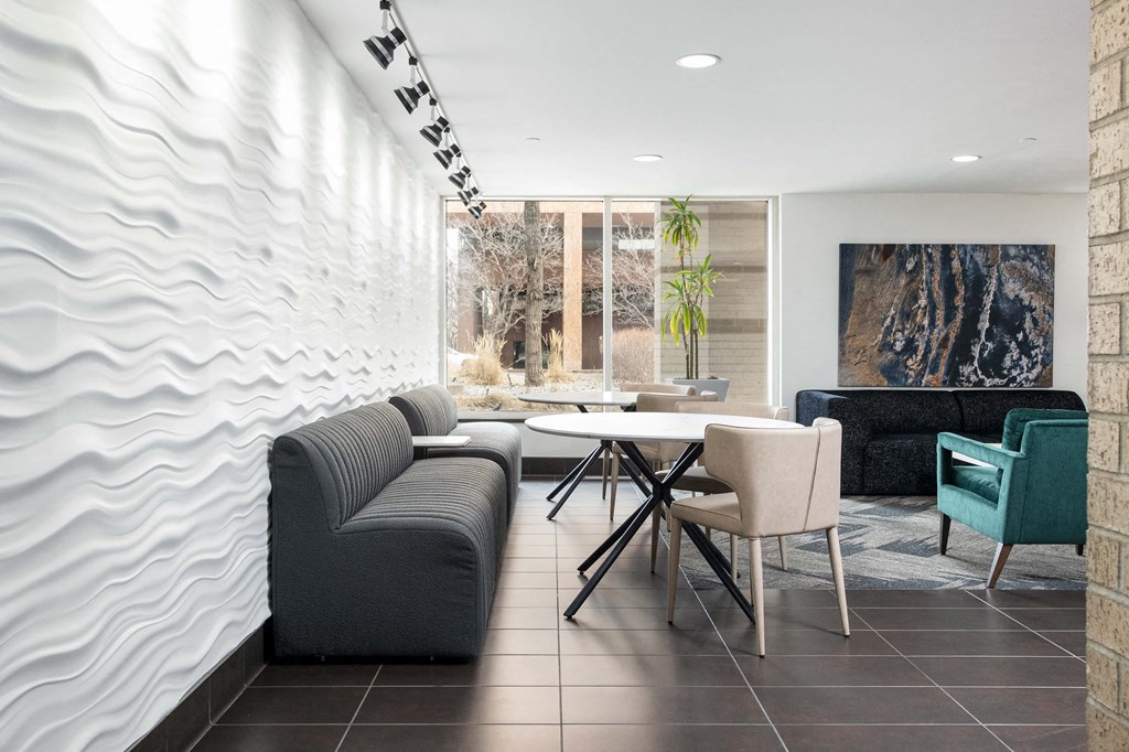 a living room with couches and a table and chairs