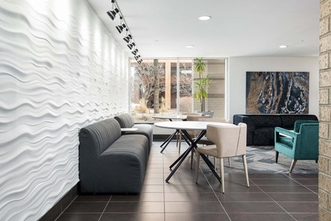 a living room with couches and a table and chairs