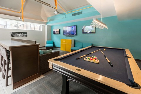 a games room with a pool table and a tv