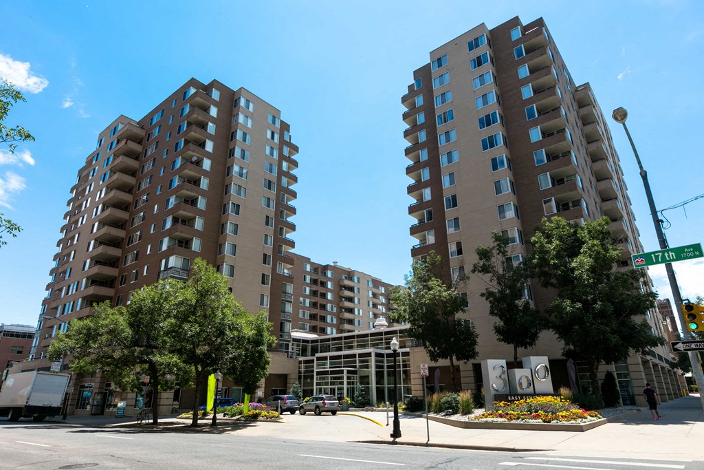 an empty street in front of two large apartment buildings