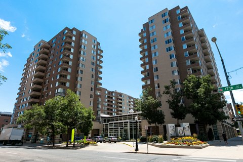 an empty street in front of two large apartment buildings