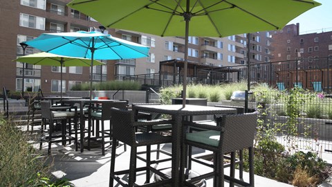 an outdoor patio with tables and umbrellas