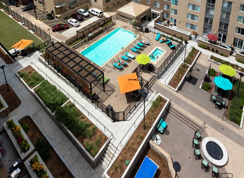 an overhead view of a swimming pool in the middle of an apartment building