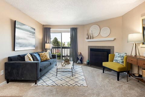 a living room with a blue couch and a fireplace