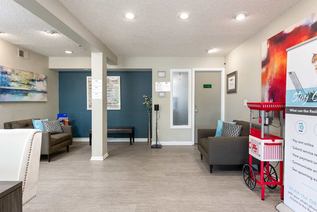 a lobby with couches and chairs and a candy machine
