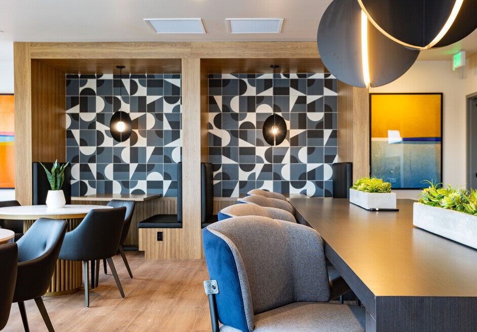 A modern dining area with a long table and chairs.