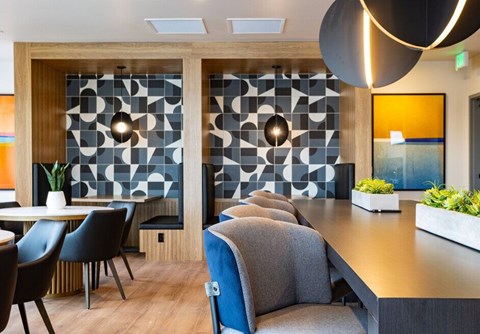 A modern dining area with a long table and chairs.