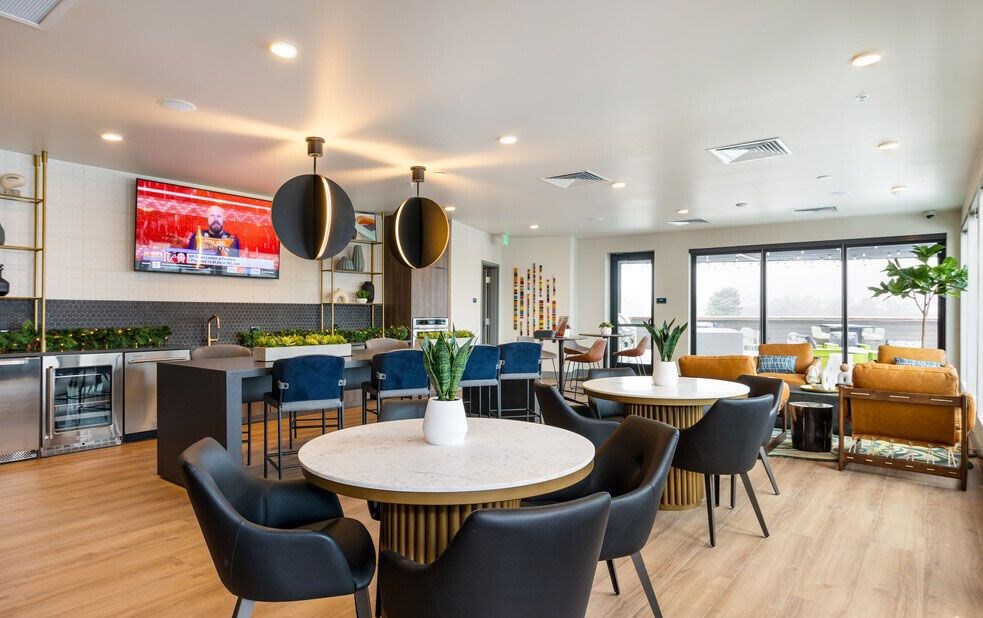 A modern dining area with a round table and chairs.