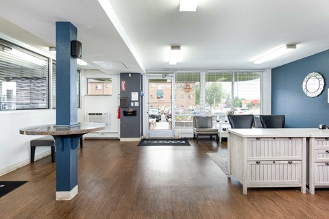 a community room with a table and chairs and a large window