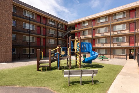 a playground in the middle of an apartment building