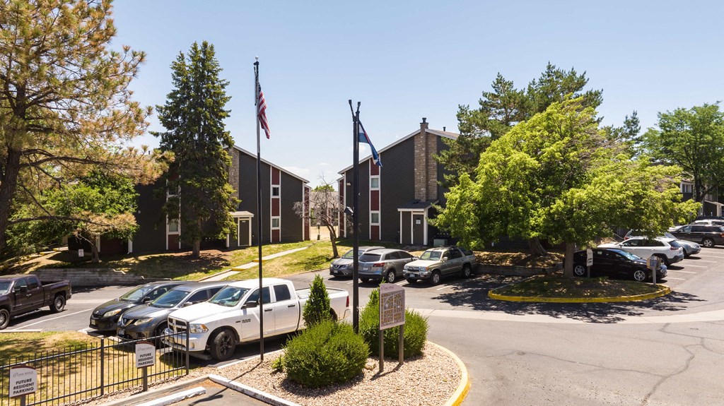a parking lot in front of a building with cars parked