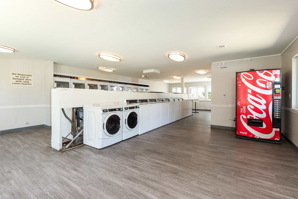 a laundry room with a coca cola coke machine