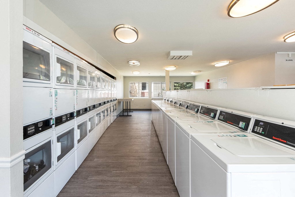 a laundry room filled with washers and dryer machines