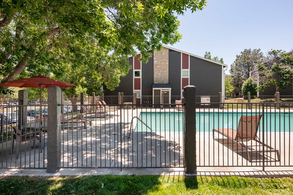 our apartments have a large pool and a patio with chairs