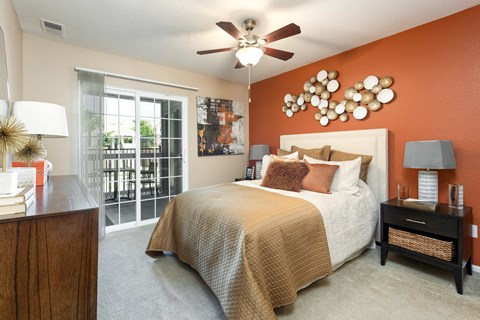 a bedroom with a bed and a ceiling fan