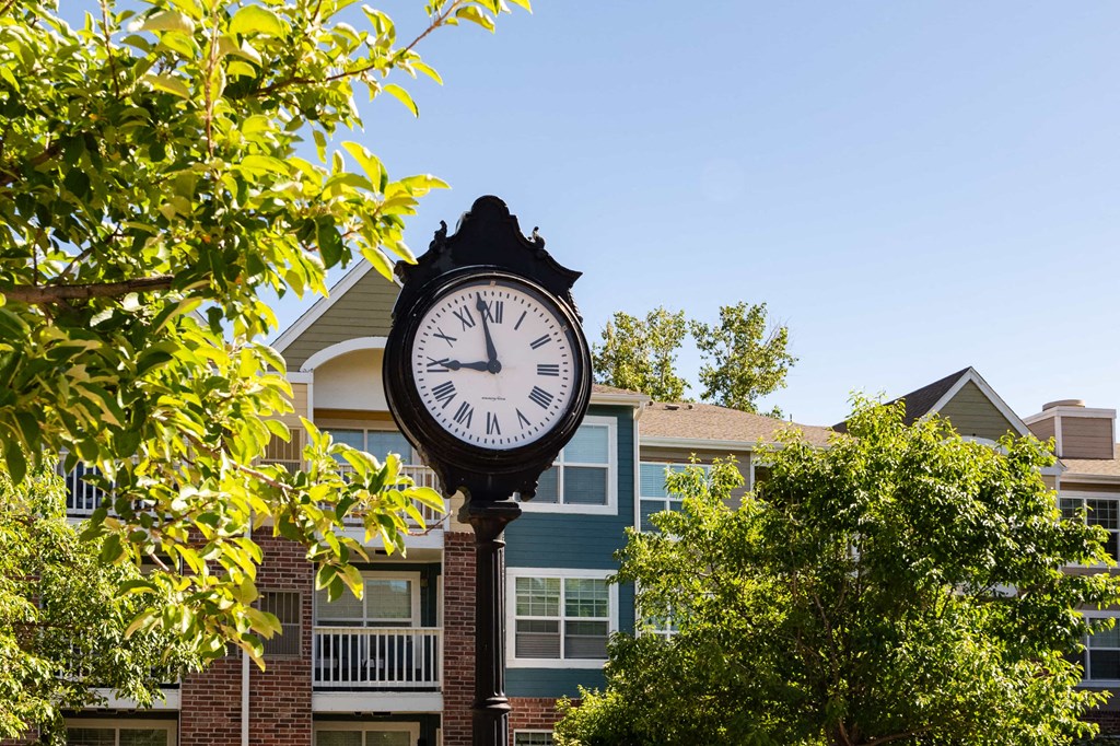 a clock on a pole in front of a building