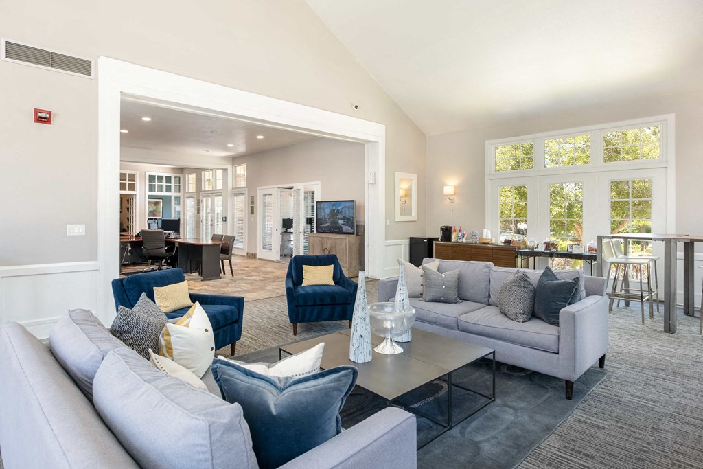 a living room with couches and chairs and a table