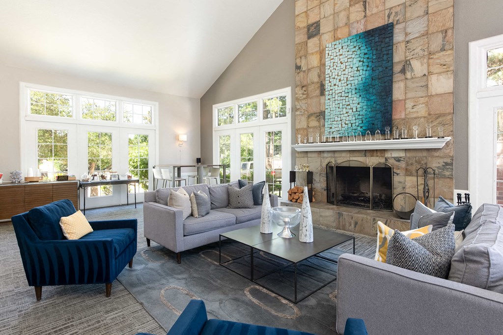a living room with couches and chairs and a fireplace