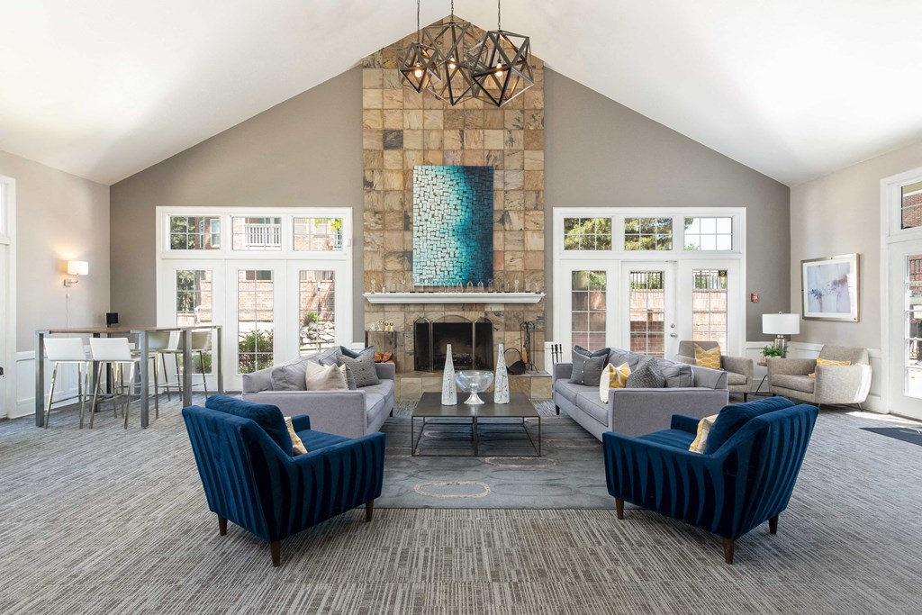 a living room with couches and chairs and a fireplace