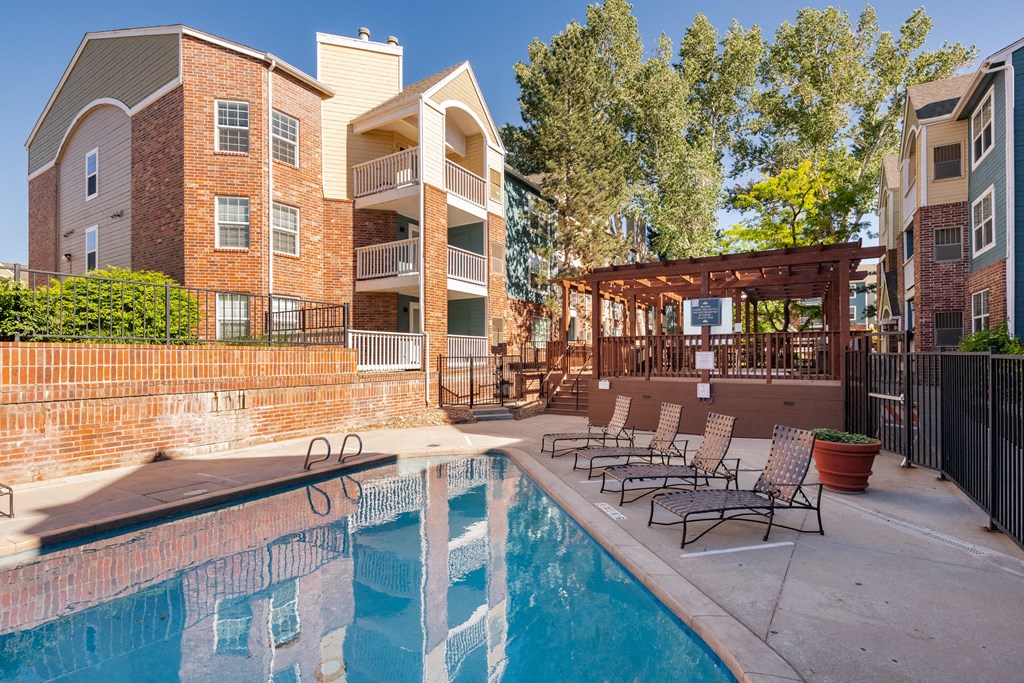 our apartments have a pool and a patio with chairs