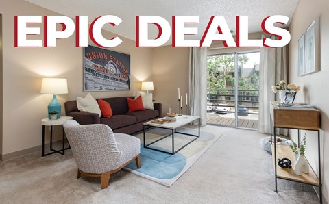 A living room with a couch, chair, and coffee table with the words "EPIC DEALS" on the wall.