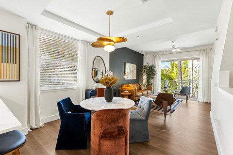 A living room with a round table and chairs.