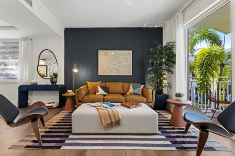A modern bedroom with a large bed and a striped rug.