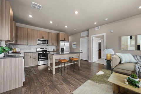 A modern kitchen with wooden cabinets and a dining table.