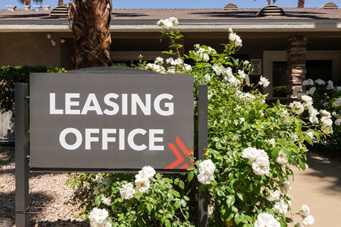 a sign that says leasing office in front of a house