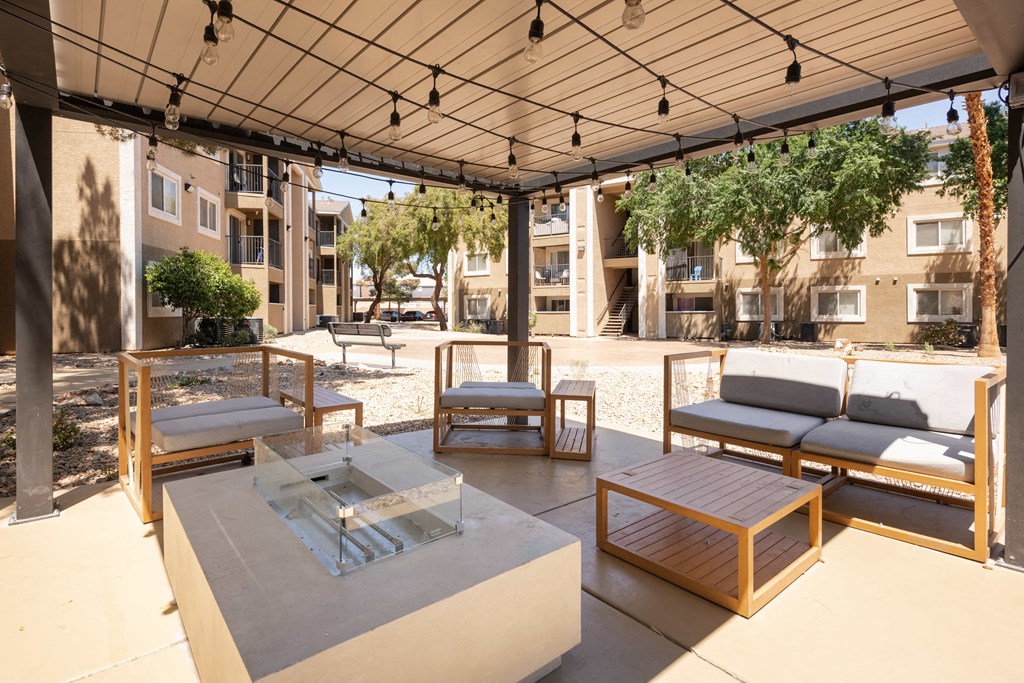 a patio with couches and tables and a glass table