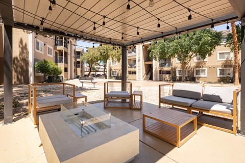 a patio with couches and tables and a glass table