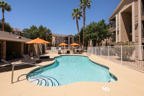 our apartments have a resort style pool with chairs and umbrellas