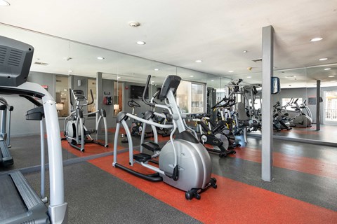 a gym with various exercise bikes and other fitness equipment