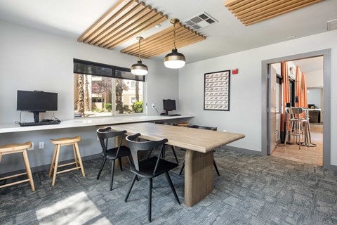 a conference room with a table and chairs and a large window