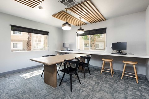 a conference room with a table and chairs and a desktop computer
