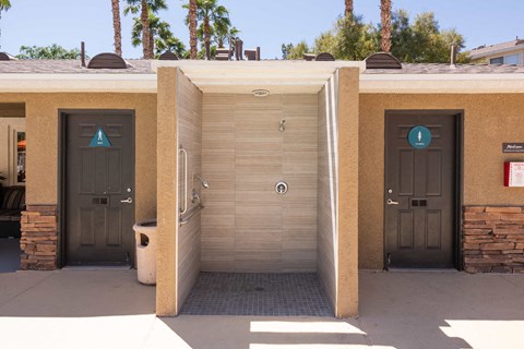 two urinals in a handicapped bathroom at a parking lot