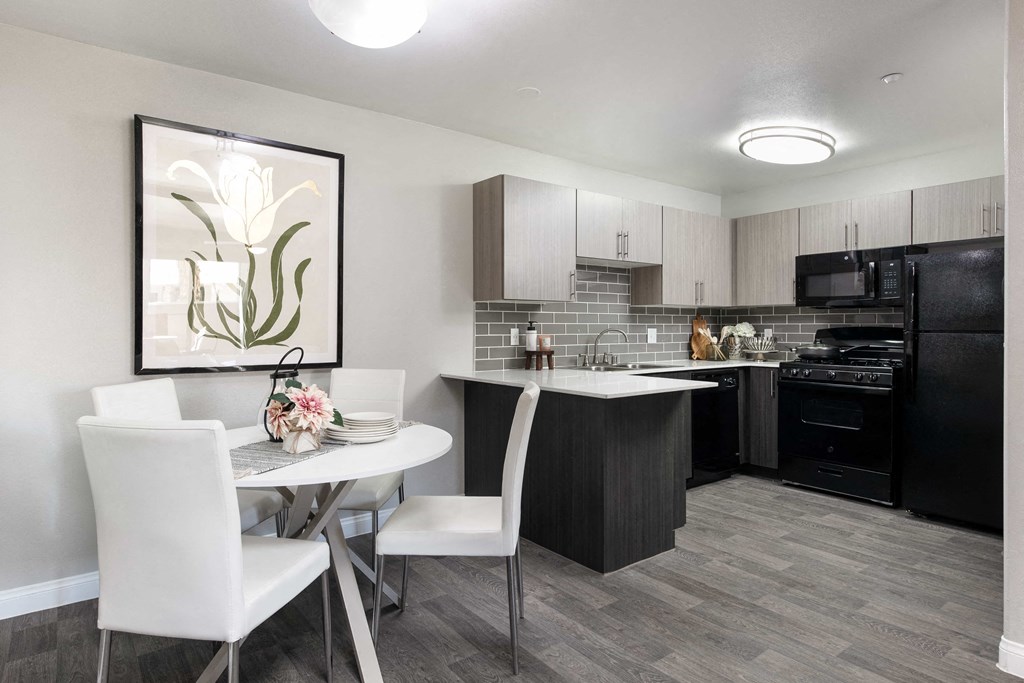 a kitchen and dining room with a table and chairs