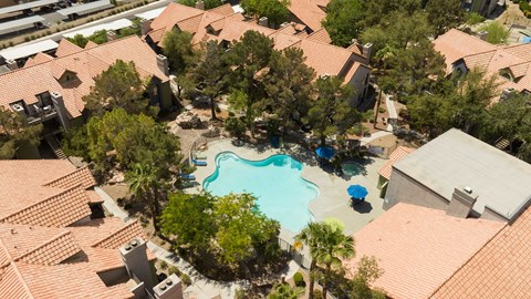 an aerial view of a swimming pool surrounded by houses