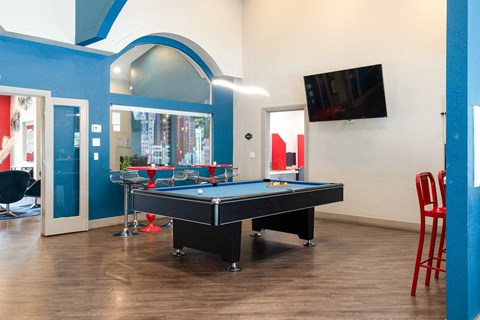 a game room with a pool table and a tv