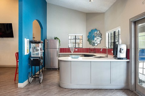 a kitchen with a counter top and a refrigerator and a sink