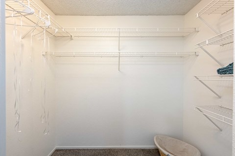 a walk in closet with a shower and a toilet