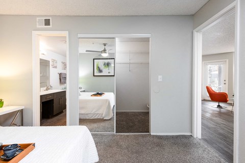 our apartments offer a bedroom and bathroom with a view of the living room and kitchen