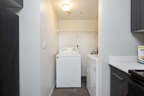 a small laundry room with a washer and dryer and a white washer