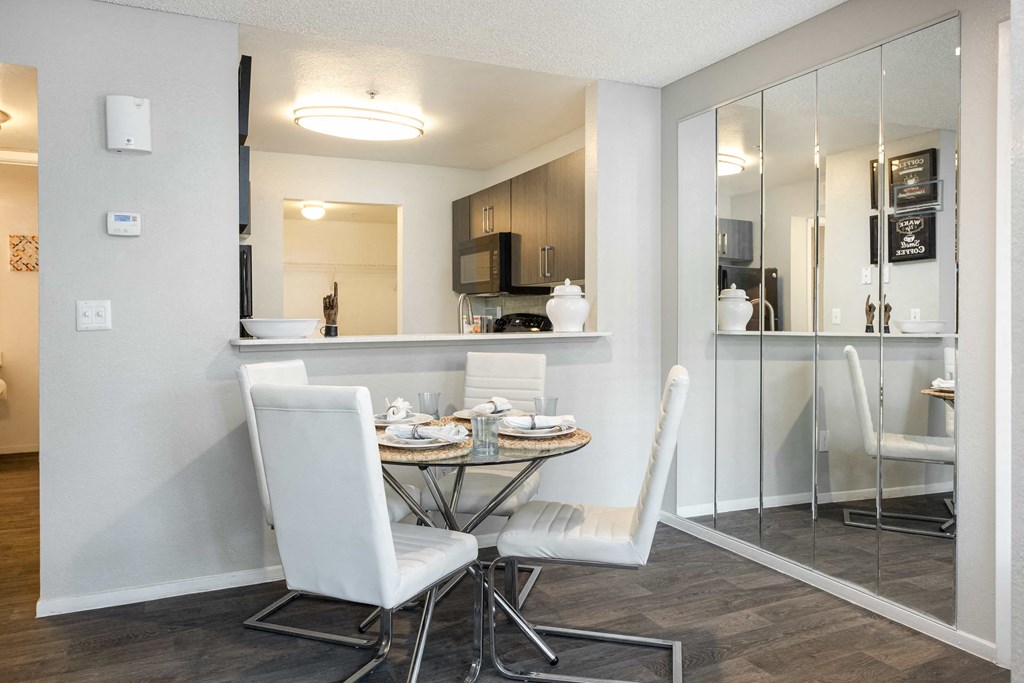 a dining room with a table and chairs and a kitchen