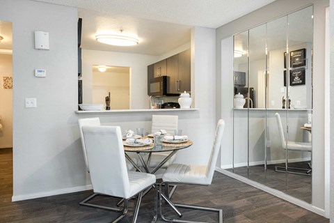 a dining room with a table and chairs and a kitchen