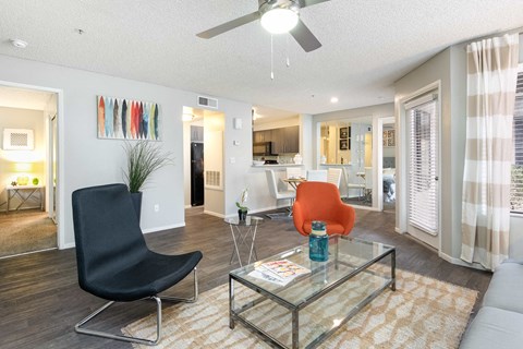 a living room with a couch and a glass table
