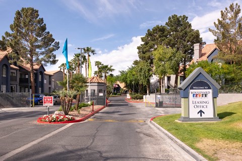 an empty street with a sign for a lease office at the end of a road