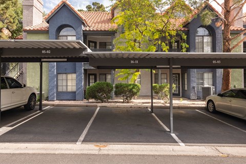 a parking lot with cars parked in front of a building
