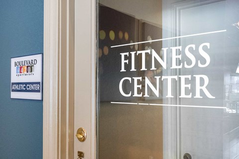 the entrance to the fitness center with a sign on the door