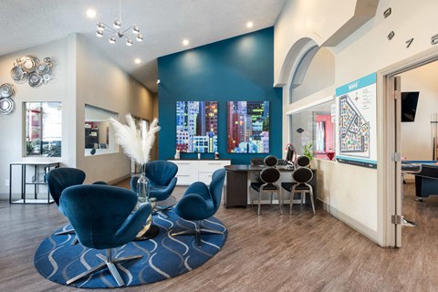 a living room with blue chairs and a table
